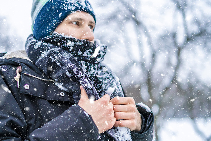 Man wrapped up warm in wintry conditions