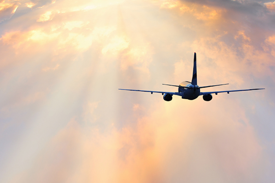 Passenger plane flying through clouds, Serjio74/iStock/Thinkstock