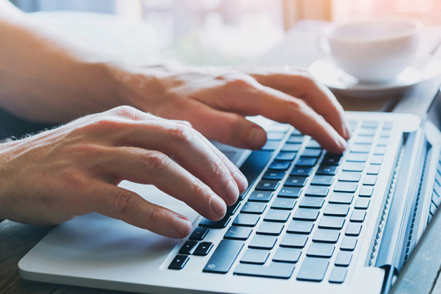 Person typing on laptop